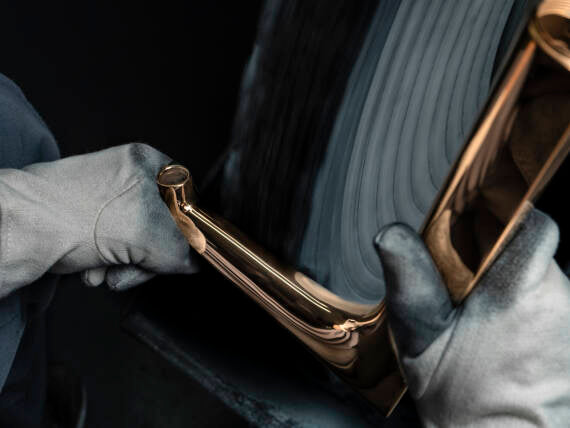 Close-up of hands holding and working on an AXOR Citterio E washbasin faucet