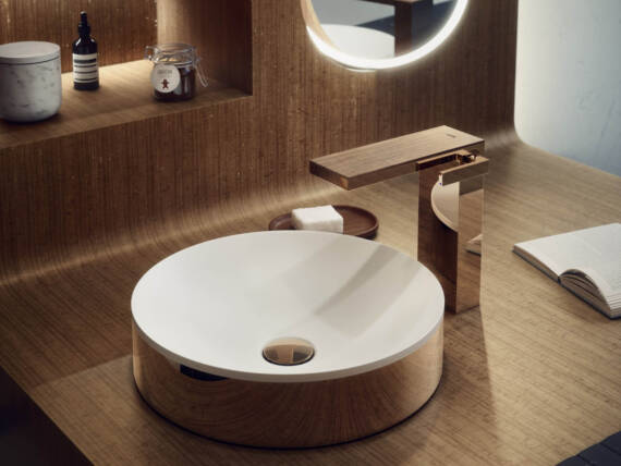 Modern bathroom with AXOR MyEdition bathroom sink faucet in Polished Red Gold and AXOR Suite Basin in Polished Red Gold.