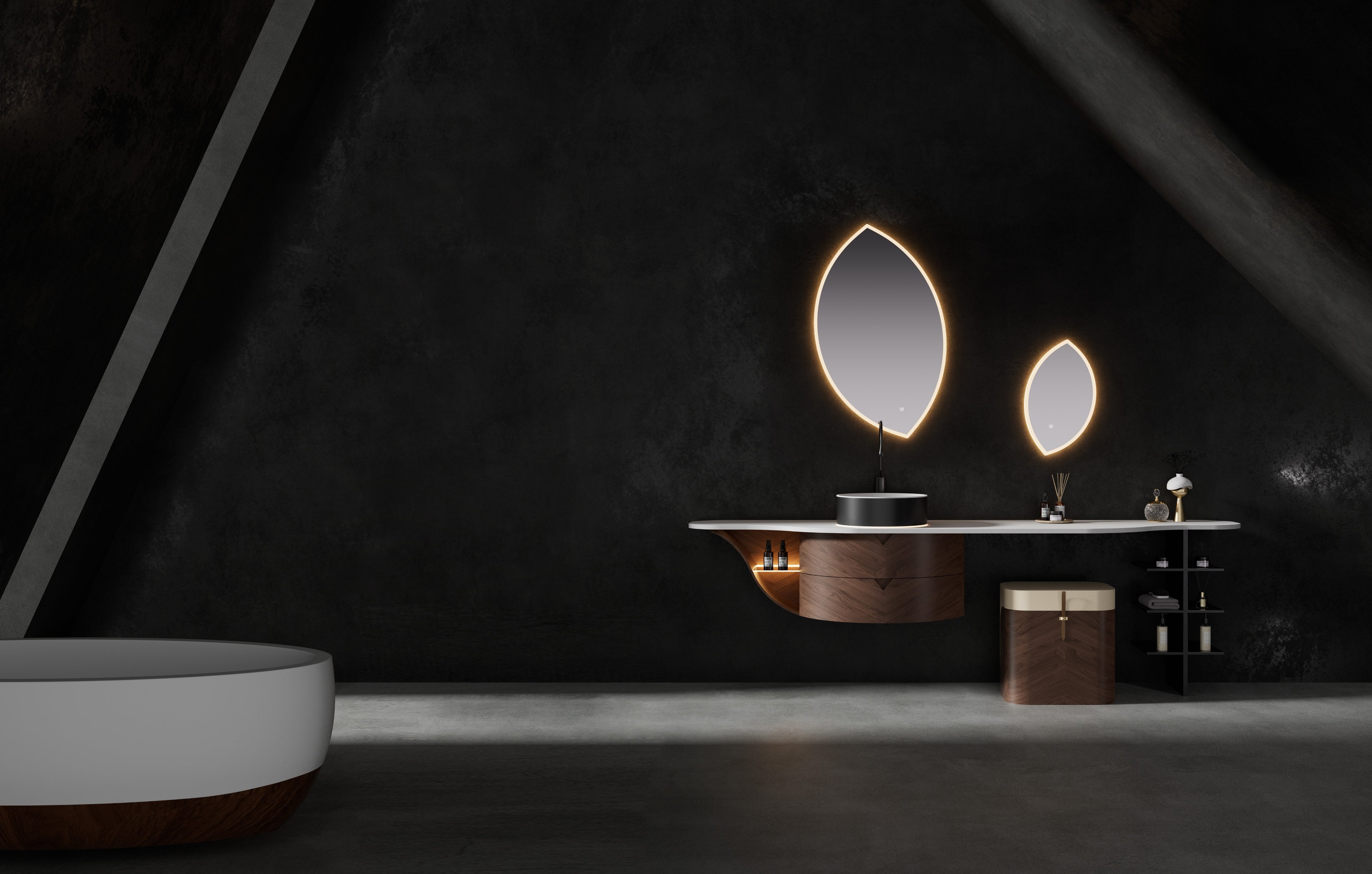 Arcana by Brandt floating wall-hung bathroom cabinet featuring a single walnut vanity with curved drawer fronts, integrated vanity table with matching dressing stool, white quartz composite countertop, illuminated gunmetal vessel basin, leaf-shaped led-mirrors, and matching freestanding bathtub.